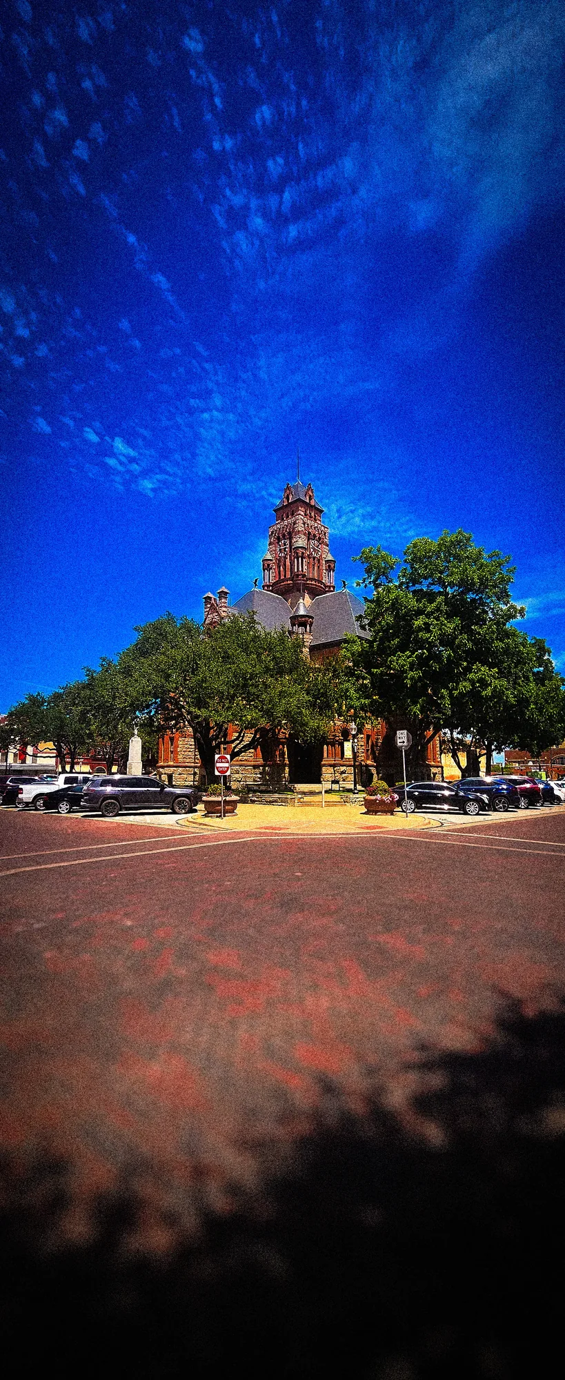 Small building and vivid trees under an intense blue sky