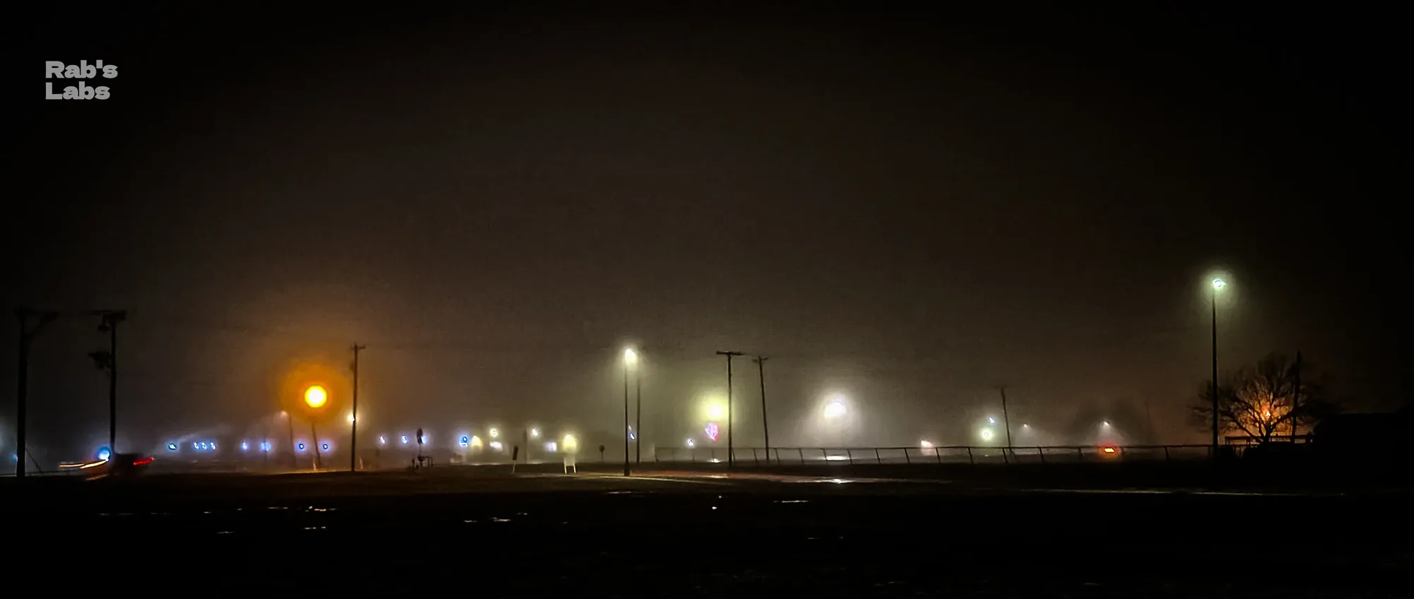 Foggy night scene with rows of amber and white lights